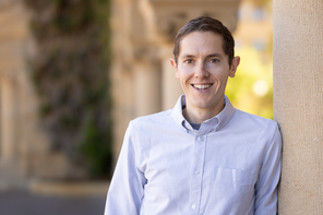 A portrait of Grant Rotskoff in the Stanford arcade