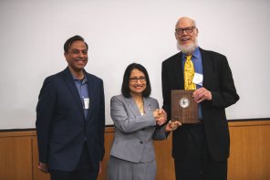 Representatives of Penn State Eberly College of Science present David Siegmund with a wooden plaque representing his Rao Prize