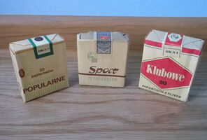 Three packets of European cigarettes sitting upright on a table