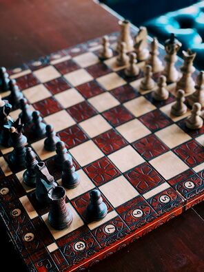 Image of wooden chess board with wooden chess pieces.