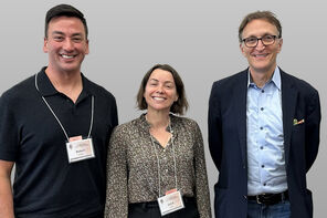 Three people pose for a photo at an event