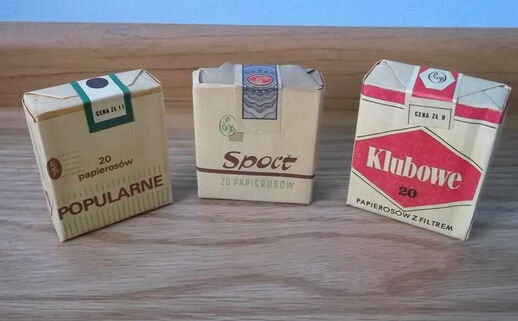 Three packets of European cigarettes sitting upright on a table