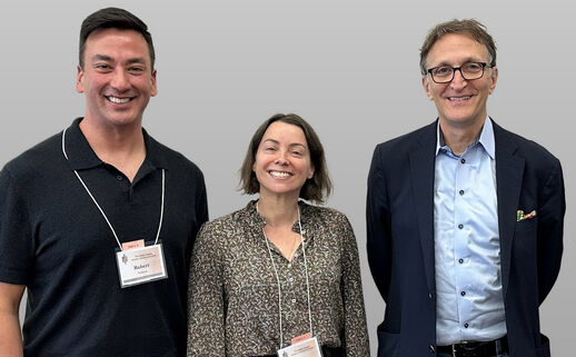 Three people pose for a photo at an event