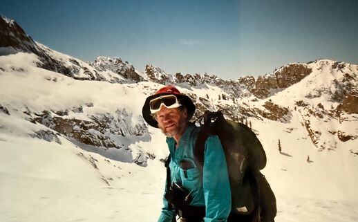 Peter Ray dressed in winter gear standing on a snowy slope