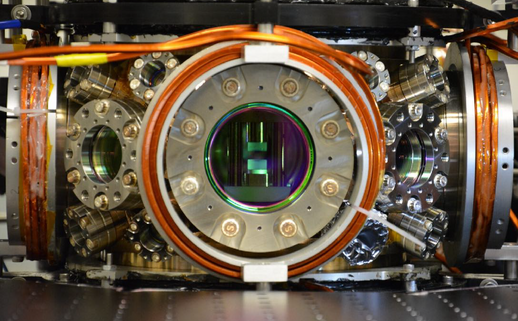 A metal piece of equipment with a round open chamber in the center