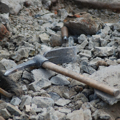 A pick lying on a pile of rocks