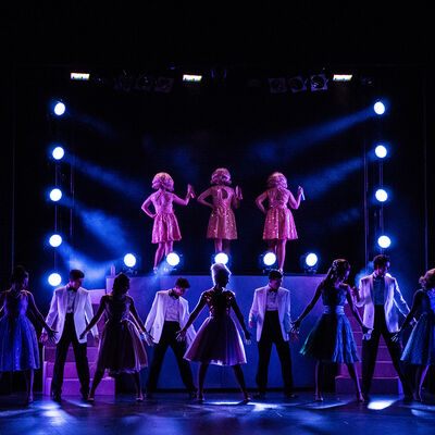 Performers on stage of a musical