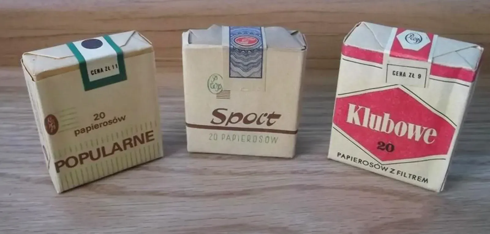 Three packets of European cigarettes sitting upright on a table