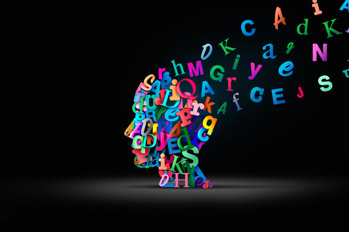 an illustration showing a head in profile made of colorful letters