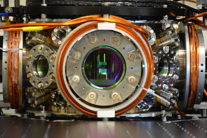 A metal piece of equipment with a round open chamber in the center