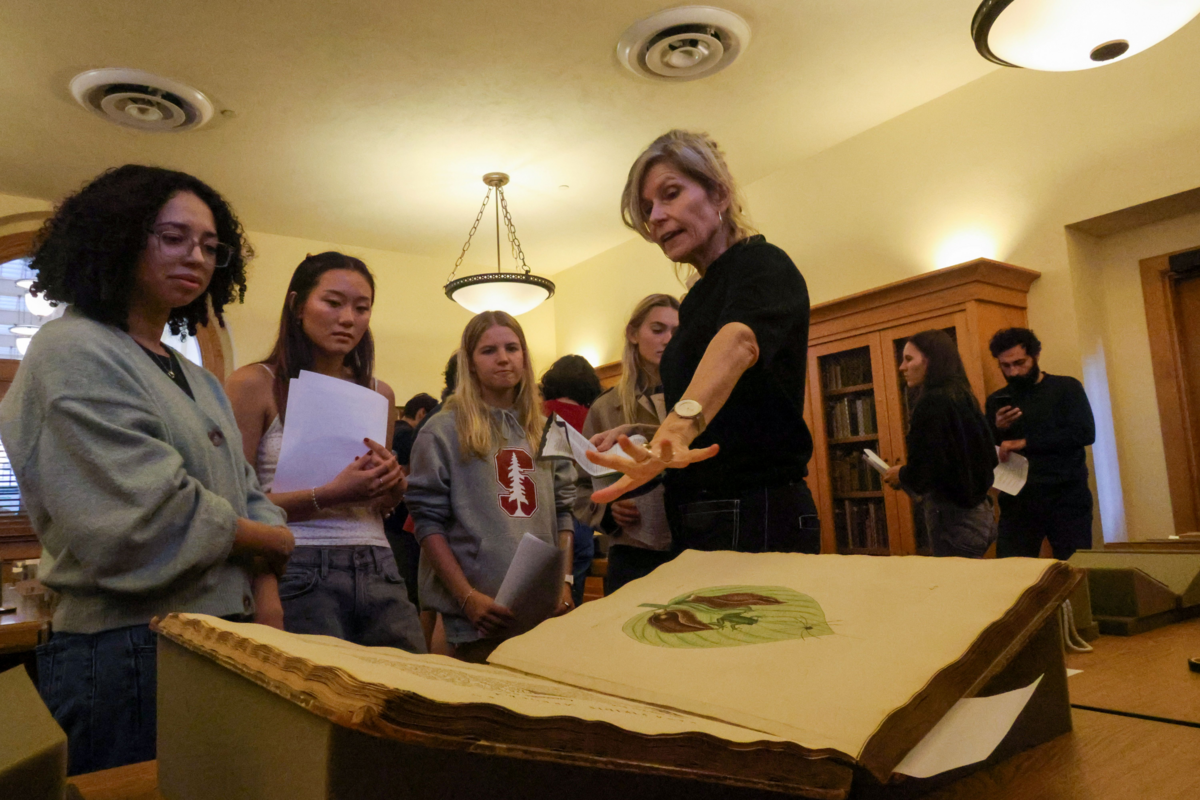 Professor Caroline Winterer discusses an archival book with students