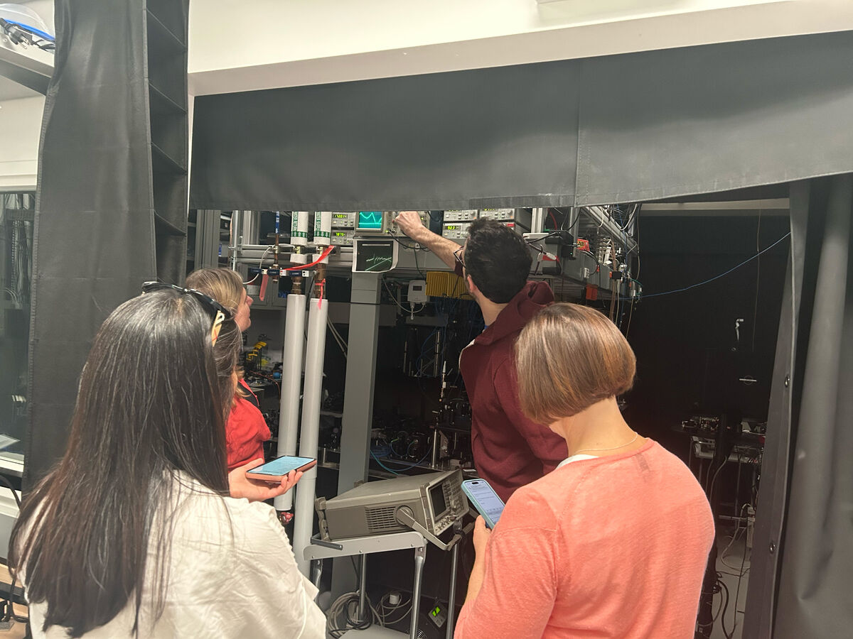 Jon Simon shows members of the PR team his cavity array microscope