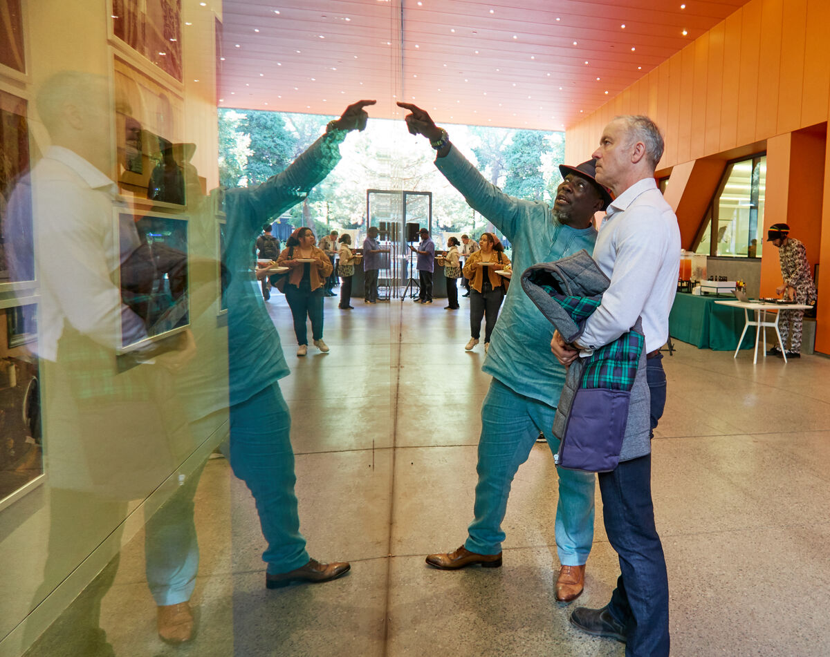 Ato Quayson and Gavin Jones look at the photography exhibition together