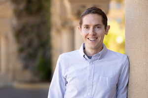A portrait of Grant Rotskoff in the Stanford arcade