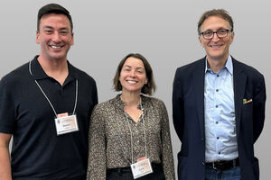 Three people pose for a photo at an event