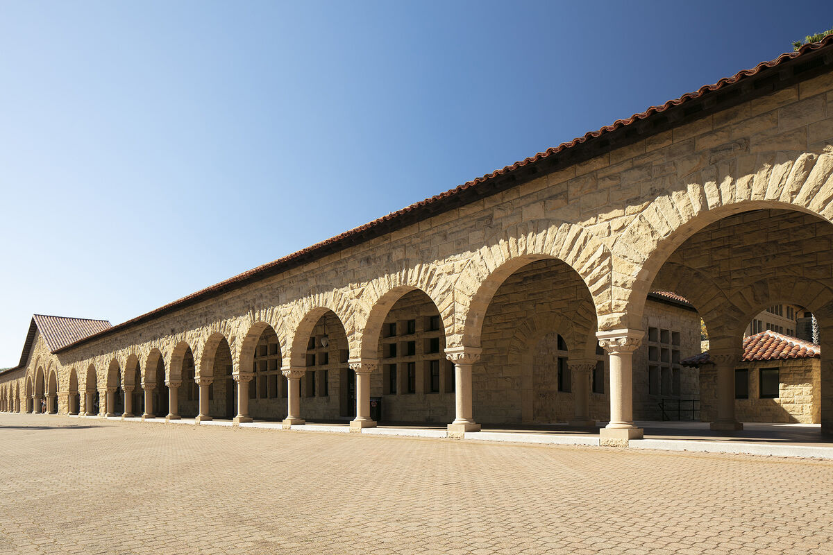 Photo of the span of sandstone arches that constitute the arcade in front of Building 1 facing Stanford's Main Quad