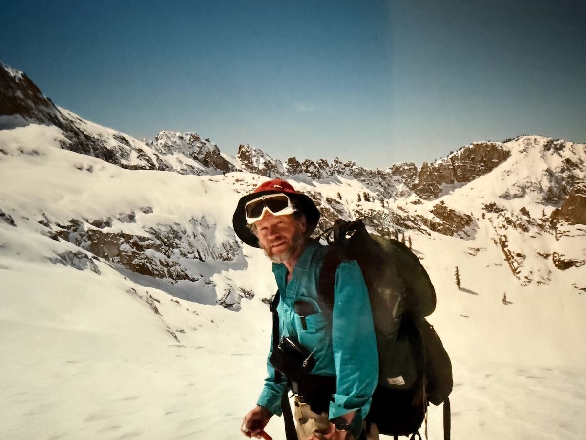 Peter Ray dressed in winter gear standing on a snowy slope