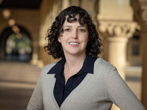 Photo of Molly Schumer wearing a being sweater over a black collared blouse