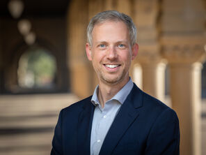 Portrait of Cory Shain in the Stanford arcade