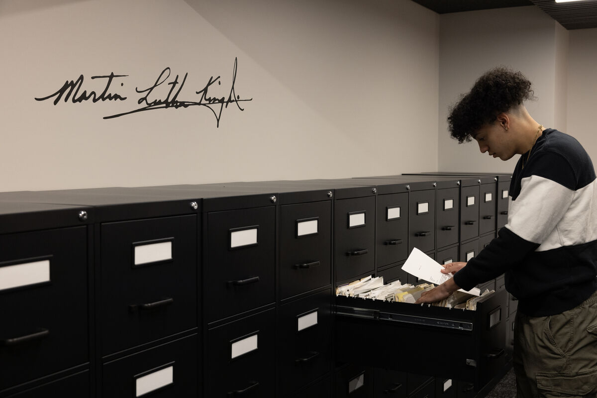 Student with the signature on the wall