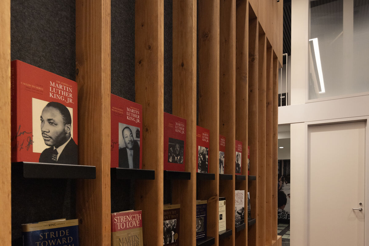 The wall of the conference room that faces the entry way holds books compiled from King's writings