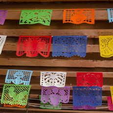 Colorful cutouts, papel picado, strung across a ceiling