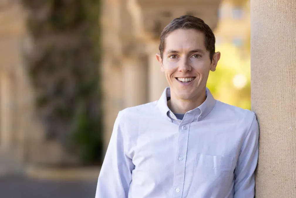 A portrait of Grant Rotskoff in the Stanford arcade