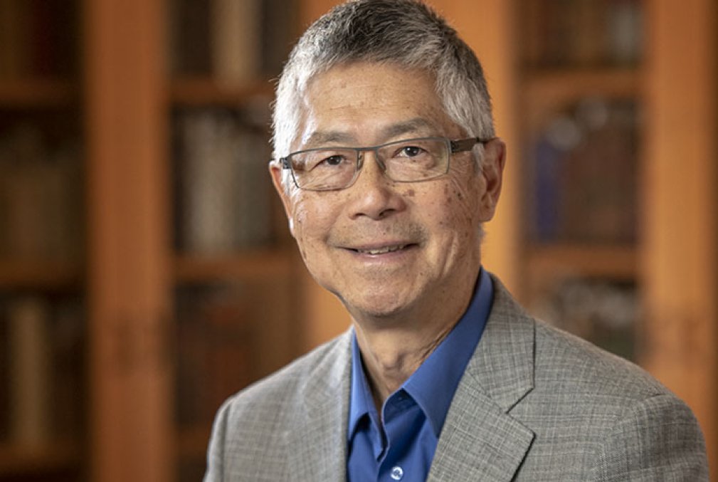 Gordon H. Chang wearing glasses, a bright-blue collared shirt, and a gray blazer