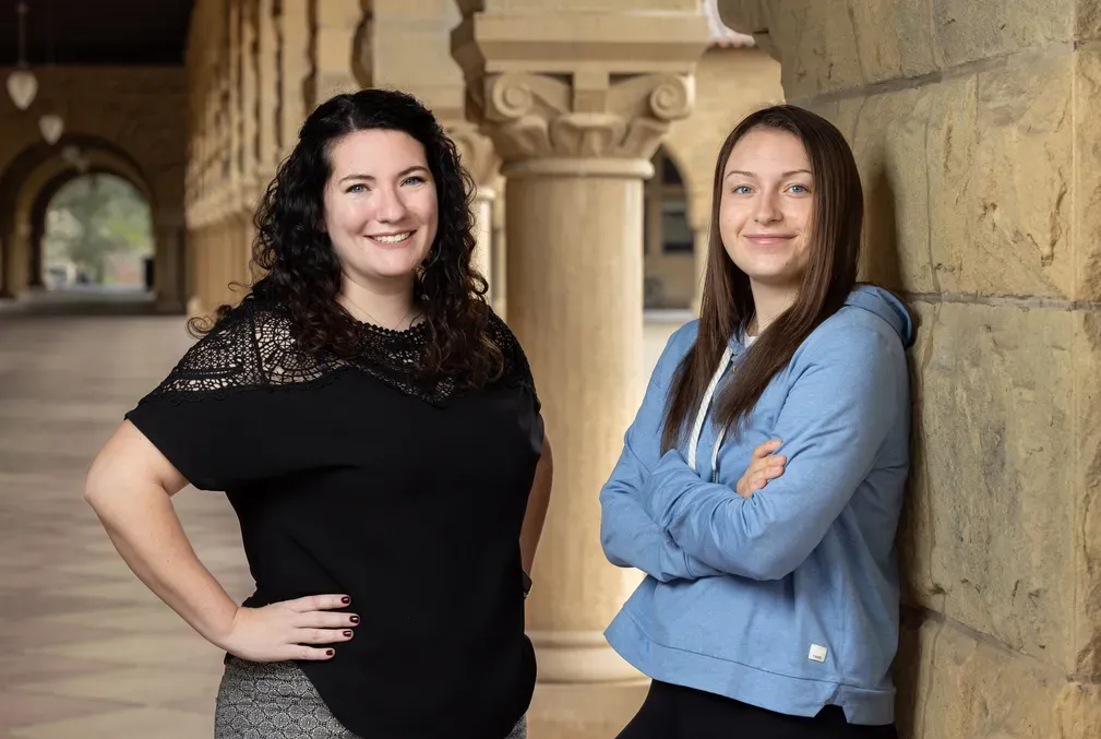 Marina Johnson and Ava Jeffs stand under the arcades along Stanford's Main Quad