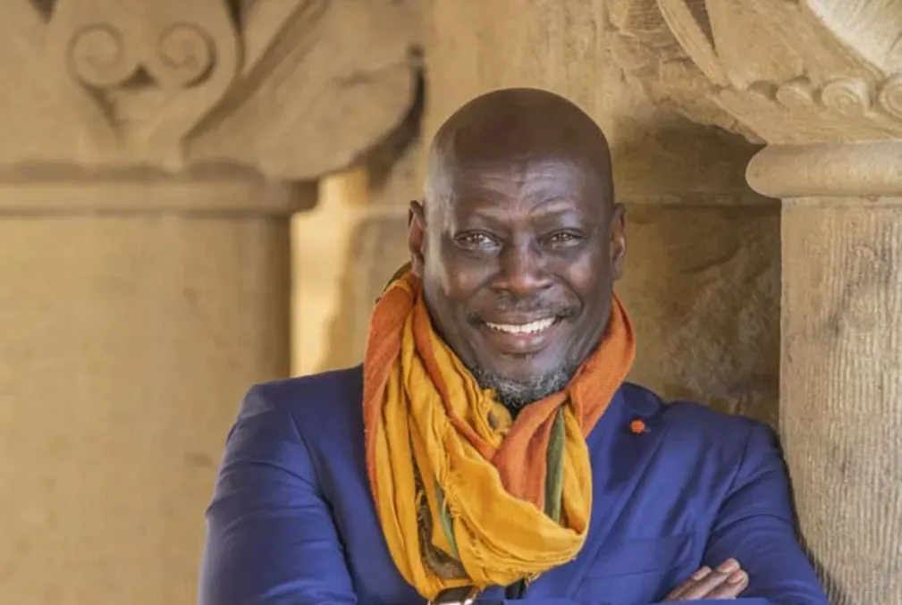 Image of Ato Quayson standing next to a pillar