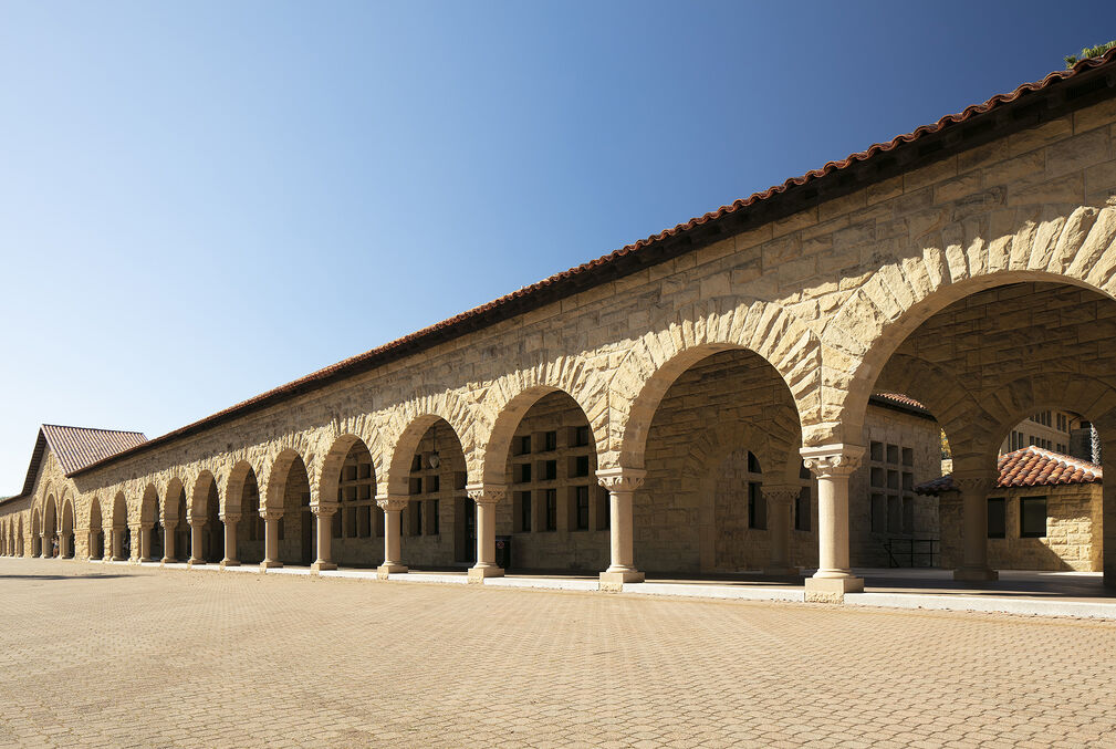 Photo of the span of sandstone arches that constitute the arcade in front of Building 1 facing Stanford's Main Quad