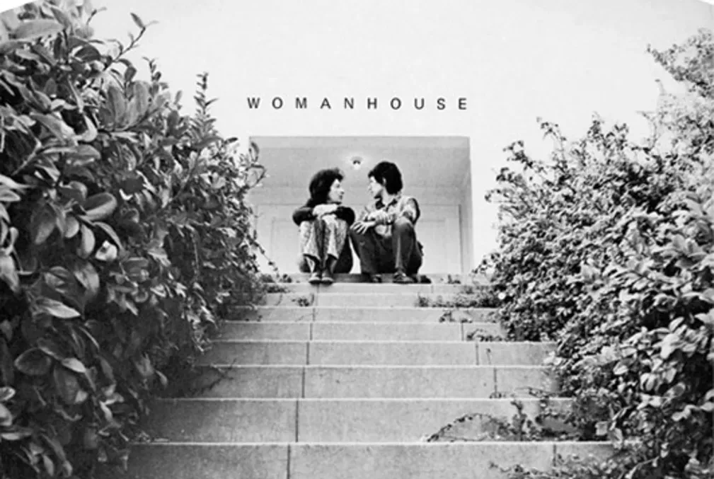 Two women face each other while sitting on steps