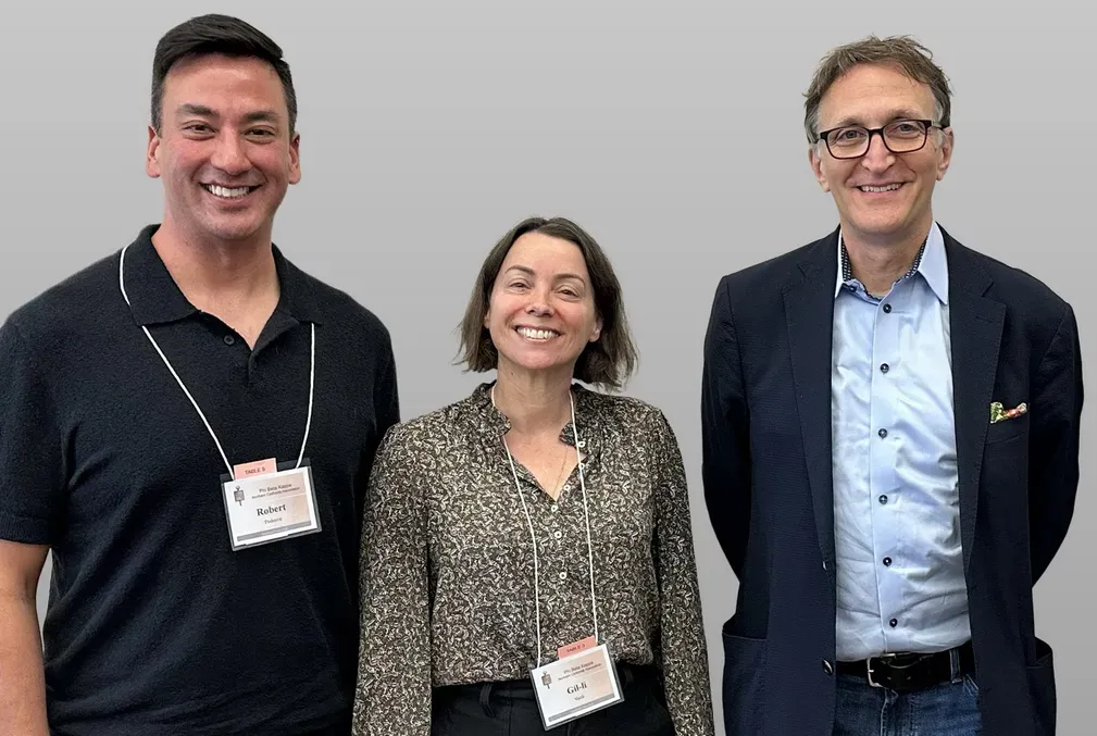 Three people pose for a photo at an event