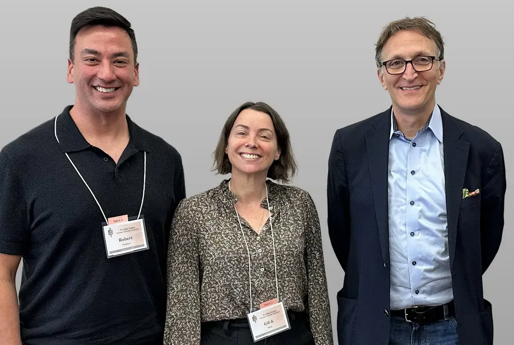 Three people pose for a photo at an event