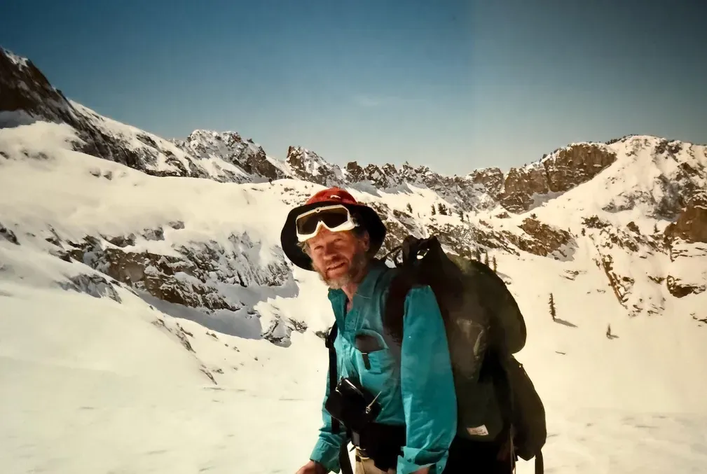 Peter Ray dressed in winter gear standing on a snowy slope
