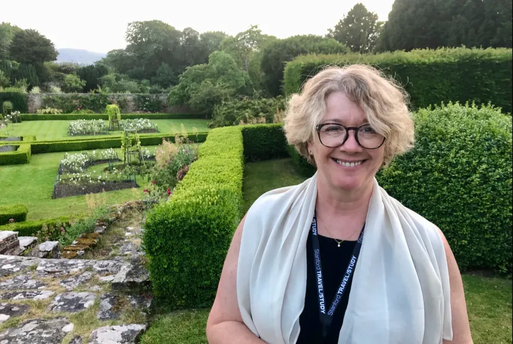 Elaine Treharne standing in a garden